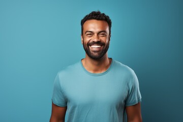 Wall Mural - smiling african american man in blue t-shirt on blue