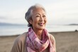 © Robert MEYNER - Portrait of happy asian senior woman on the beach at summer
