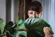 © leszekglasner - Woman taking care treatments on plants in the home jungle