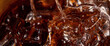 Pouring of Cola and Ice. Cola soda and ice splashing fizzing or floating up to top of surface. Close up of ice in cola water. Texture of carbonate drink with bubbles in glass. Cold drink background