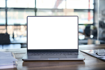 Laptop pc mock up template design on office workplace desk, white mockup empty blank computer screen on office work table business web technology at modern workspace, closeup.