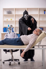 Wall Mural - Old male patient visiting two devil doctors
