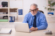 © Elnur - Old male employee working in the office