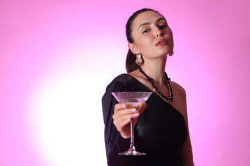 Wall Mural - Beautiful woman with martini on pink background