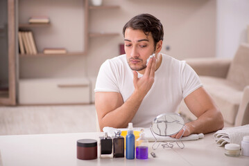 Wall Mural - Young man shaving face at home