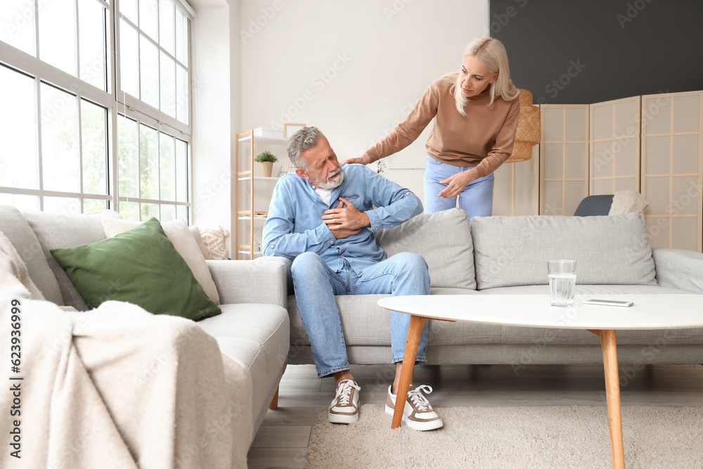 Mature woman and her husband having heart attack at home