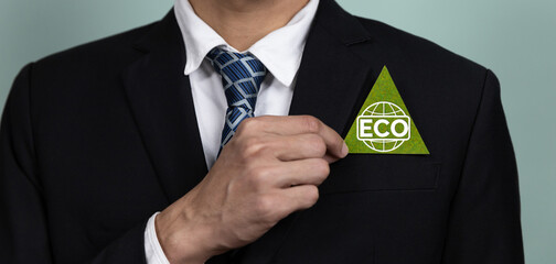 Eco-friendly corporate promoting sustainable and green business concept with businessman hold ECO symbol paper as environmental protection commitment using clean energy with zero CO2 emission. Alter