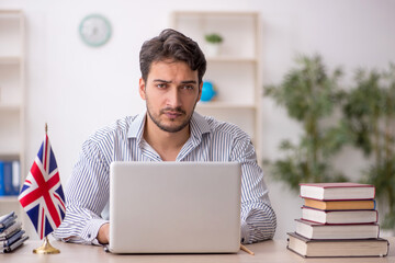 Wall Mural - Young male translator sitting in the office