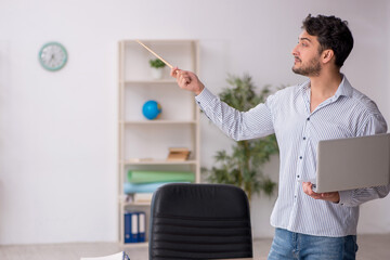 Wall Mural - Young male student employee in tele-education concept