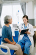 © Nuttapong punna - Caucasian doctor smiling take care of a young patient in hospital. Friendly nurse or therapeutic treat client Professional medical service concept.