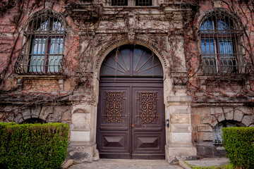 Facade of a old european historical building with vintage windows and doors