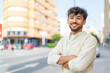 © luismolinero - Young Arabian handsome man at outdoors with arms crossed and looking forward