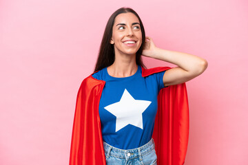 Wall Mural - Super Hero Caucasian woman isolated on pink background thinking an idea