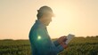 © SUPER FOX - Embracing golden breathtaking sunset, modern farmer harnesses power digital technologies revolutionize agriculture. Witness silhouette dedicated agronomist work wonders field, using tablet optimize
