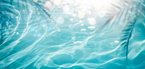 Wall Mural - abstract sea with defocused lights and shadow of palm leaves