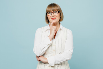 Blonde confident successful employee business woman 50s wears white classic suit glasses formal clothes prop up chin look camera isolated on plain pastel blue background. Achievement career concept.