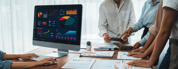 Leinwandbilder - Panorama shot analyst team utilizing BI Fintech to analyze financial report with laptop. Businesspeople analyzing BI power dashboard displayed on laptop screen for business insight. Scrutinize