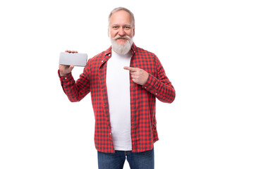 handsome 60s middle aged mature man in stylish shirt showing advertisement on smartphone