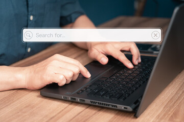 Poster - User working with laptop computer on table in office. Search engine optimization the internet with search bar. Best SEO technology networking, Searching browsing internet data information concept.