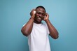 © Ivan Traimak - 30 year old American male adult in white t-shirt enjoys listening to favorite music with headphones