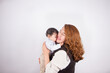 © artrolopzimages - Beautiful photo of loving mom with baby on light photo studio background. Family and baby concept.
