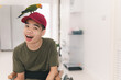 © GAYSORN - Confidente teenage boy wearing red cap with big smile, joy face and his pet,Sun Conure on his head, Animals therapy for person with disability, Hobby,Rehabilitation friendship of best friends concept.