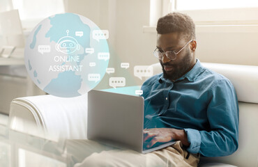 Black man sitting on couch, using laptop with Online Assistant