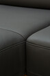 Corner sofa made of leather. Photograph of details in an interesting light