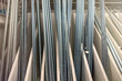 Threaded rods or threaded studs. Galvanized metal rod with threads along the entire length. Long threaded studs of different thicknesses in a hardware store.