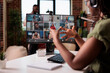canvas print picture - African american startup employee working from home gesturing in video conference with colleagues at desk. Small business owner talking with team in internet call on personal computer with webcam.