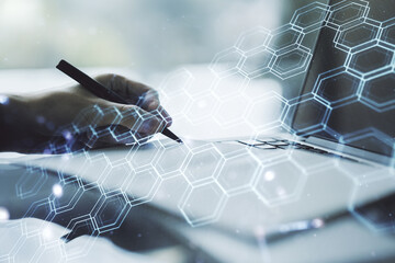 Poster - Creative concept of wireless technology with hexagon hologram and hand writing in notebook on background with laptop. Big data and database concept. Multiexposure