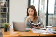 © aekachai - Asian business woman looking at financial documents