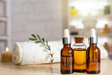 Bottles on the background of the spa room. Skin care serum or natural cosmetics with essential oil. face and body beauty concept. Spa concept. Place for text.