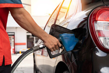 Car Refueling On Petrol Station. Fuel Pump At Station. Refueling The Car At A Gas Station Fuel Pump. Man Driver Hand Refilling And Pumping Gasoline Oil