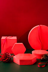 Poster - Red pedestal product display and ribbon on red and dark green background with modern geometric block,christmas background