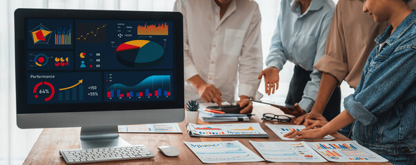 Fototapete - Panorama shot analyst team utilizing BI Fintech to analyze financial report with laptop. Businesspeople analyzing BI power dashboard displayed on laptop screen for business insight. Scrutinize