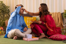 Sister Applying Tilaka On Her Brother's Forehead On The Occasion Of Raksha Bandhan