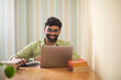 © IndiaPix - Young man working with laptop in his home office