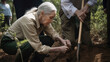 © Robert Kneschke - Senior scientist planting tree for environment