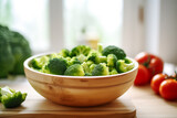 Fototapeta Mapy - A bowl full of broccoli on a wooden kitchen counter. Nicely lit scene, boho style surroundings with accessories around created by generative ai