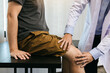 © wutzkoh - Asian physiotherapists are checking patients' knees.