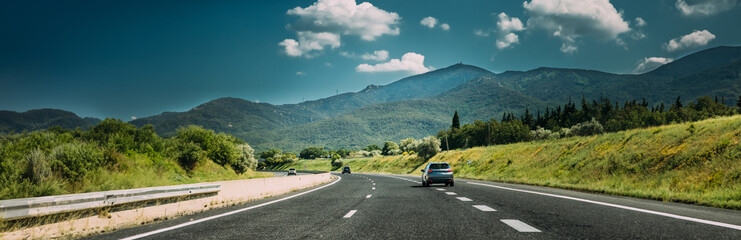 Compact Crossover SUV In Motion On Road, Freeway, Motorway, Highway In Mountains Landscape. Drive And Travel Concept