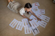 © Михаил Решетников - A woman lies on the floor and looks at sketches of swimwear and underwear.
