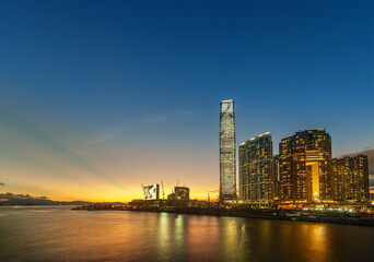 Wall Mural - Skyscraper, skyline and harbor of Hong Kong city at dusk