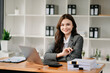 © Nuttapong punna - Beautiful woman using laptop and tablet while sitting at her working place. Concentrated at work..