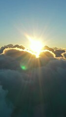 Wall Mural - flying above the clouds. aerial view of clouds and morning sun. traveling by air perfect background.