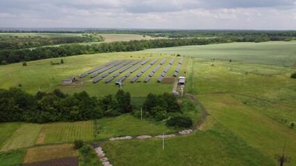 Aerial view of Solar Panels Farm solar cell with sunlight. Drone flight over solar panels field, renewable green alternative energy concept.