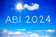 ABI 2024 written on sunny blue sky. Translation: German sign for succesfully completed high school graduation exams, concept of achievement and freedom.
