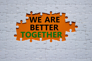 we are better together symbol. white puzzle with words we are better together. beautiful orange back