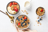 Fototapeta Desenie - Breakfast oat granola bowl with fresh berries and oat milk, table top view, flat lay food photo composition
